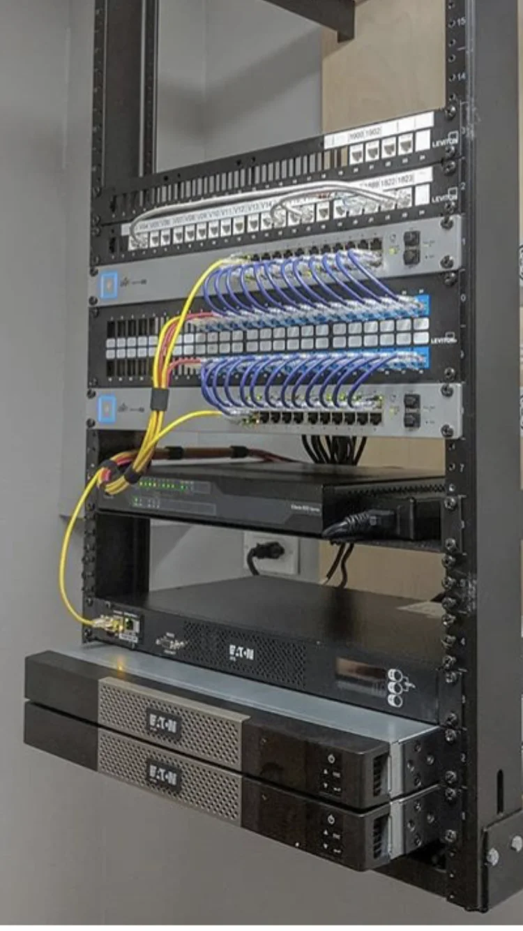 Installed network rack with patch panels, switches, and organized cable management