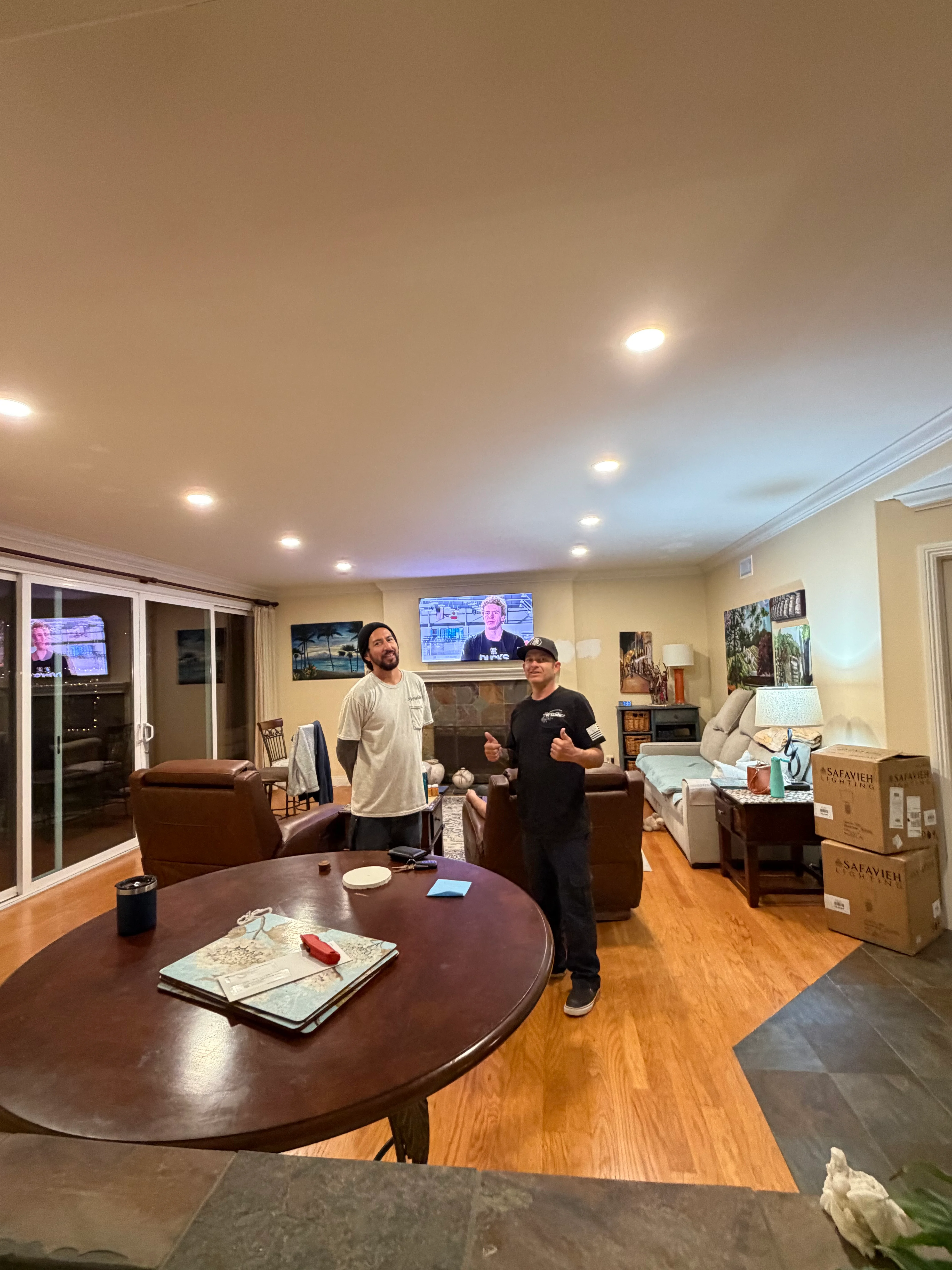 Recessed LED ceiling lights installed in modern living room with hardwood floors
