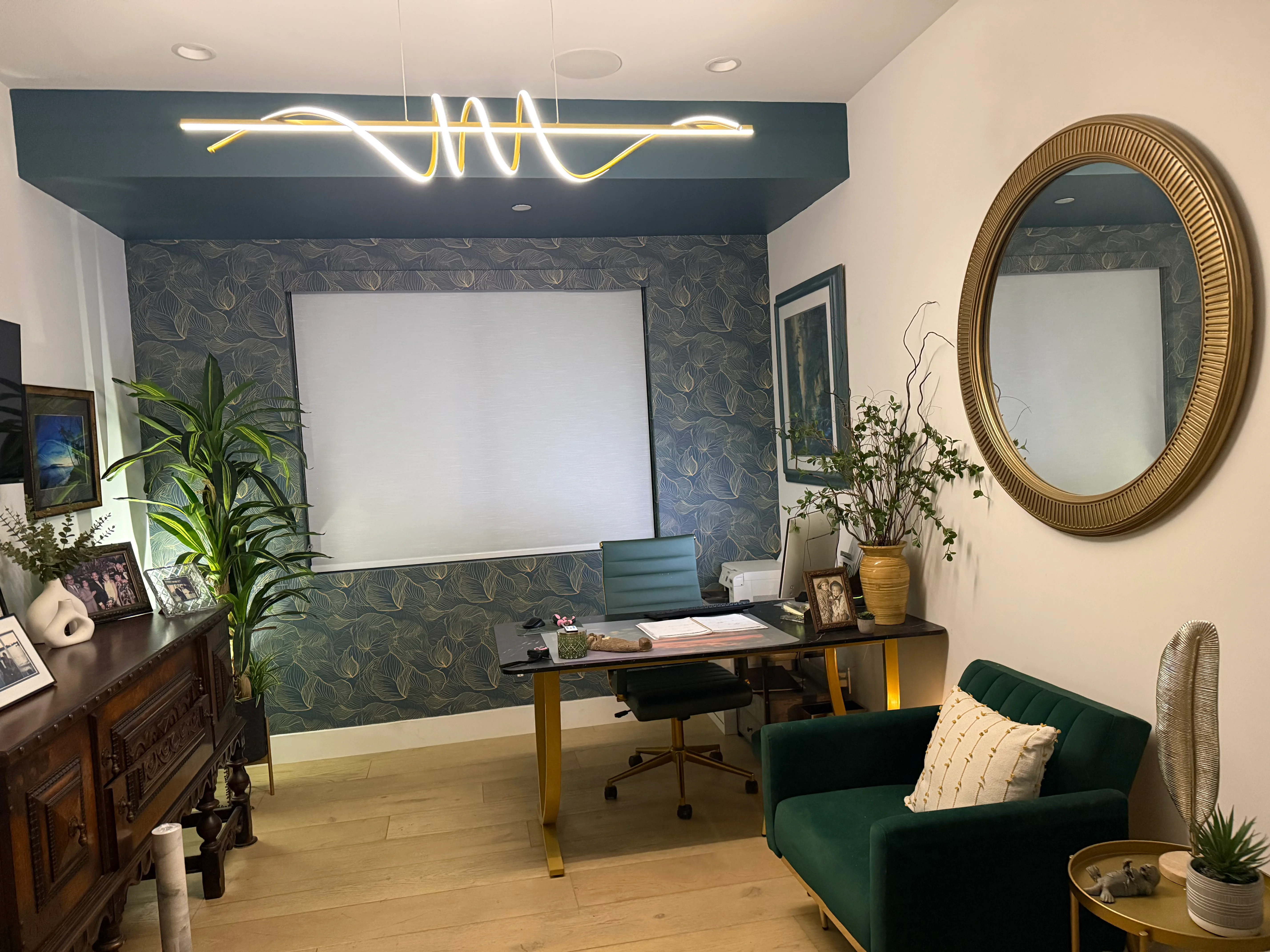 Modern office with white and gold neon wave sign mounted on teal accent wall above whiteboard