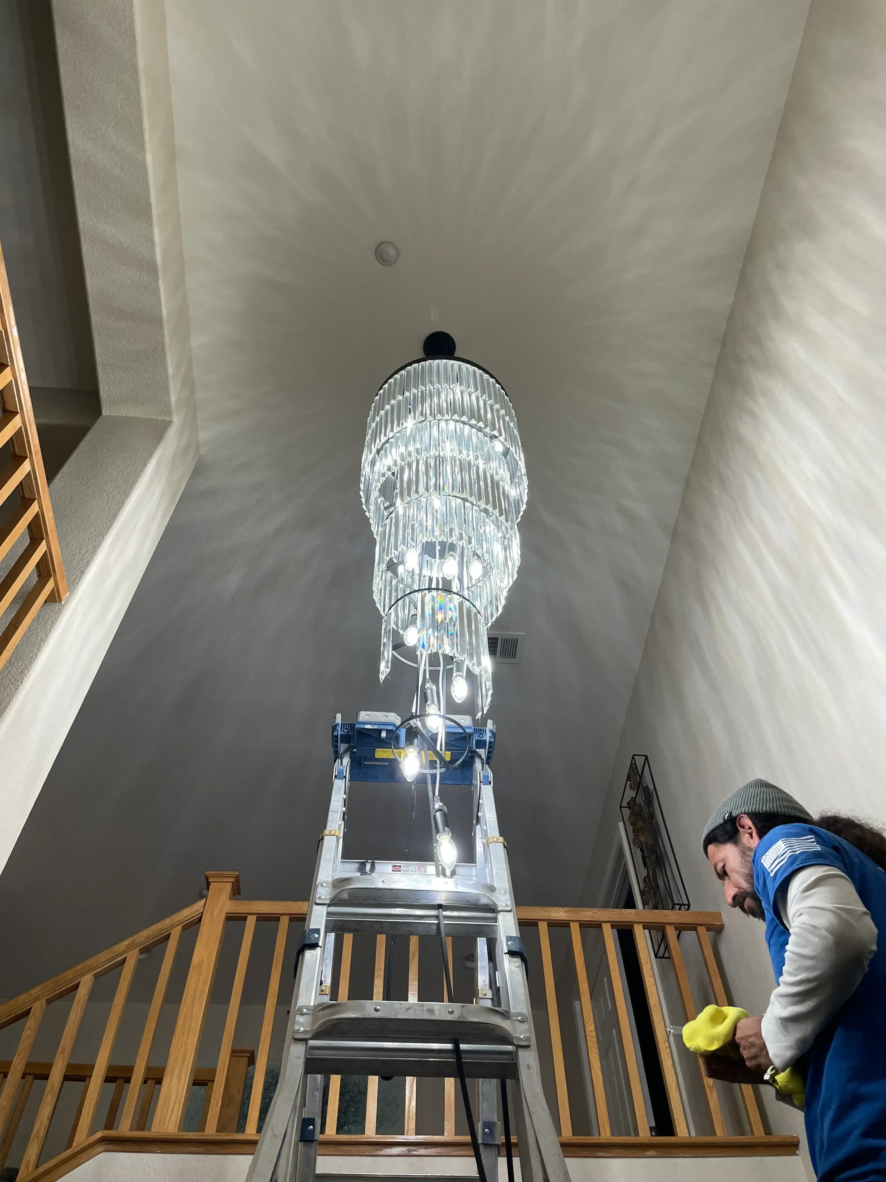 Electrician installing recessed ceiling light fixture in drywall ceiling